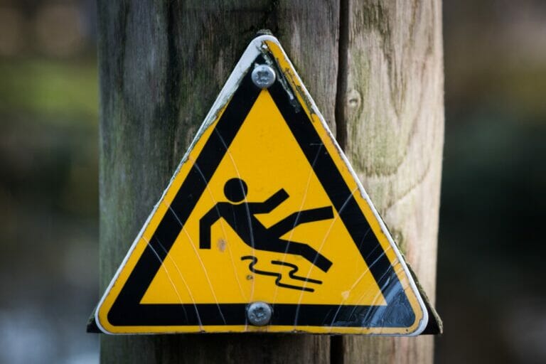 Wet floor warning sign and unsafe walkway conditions